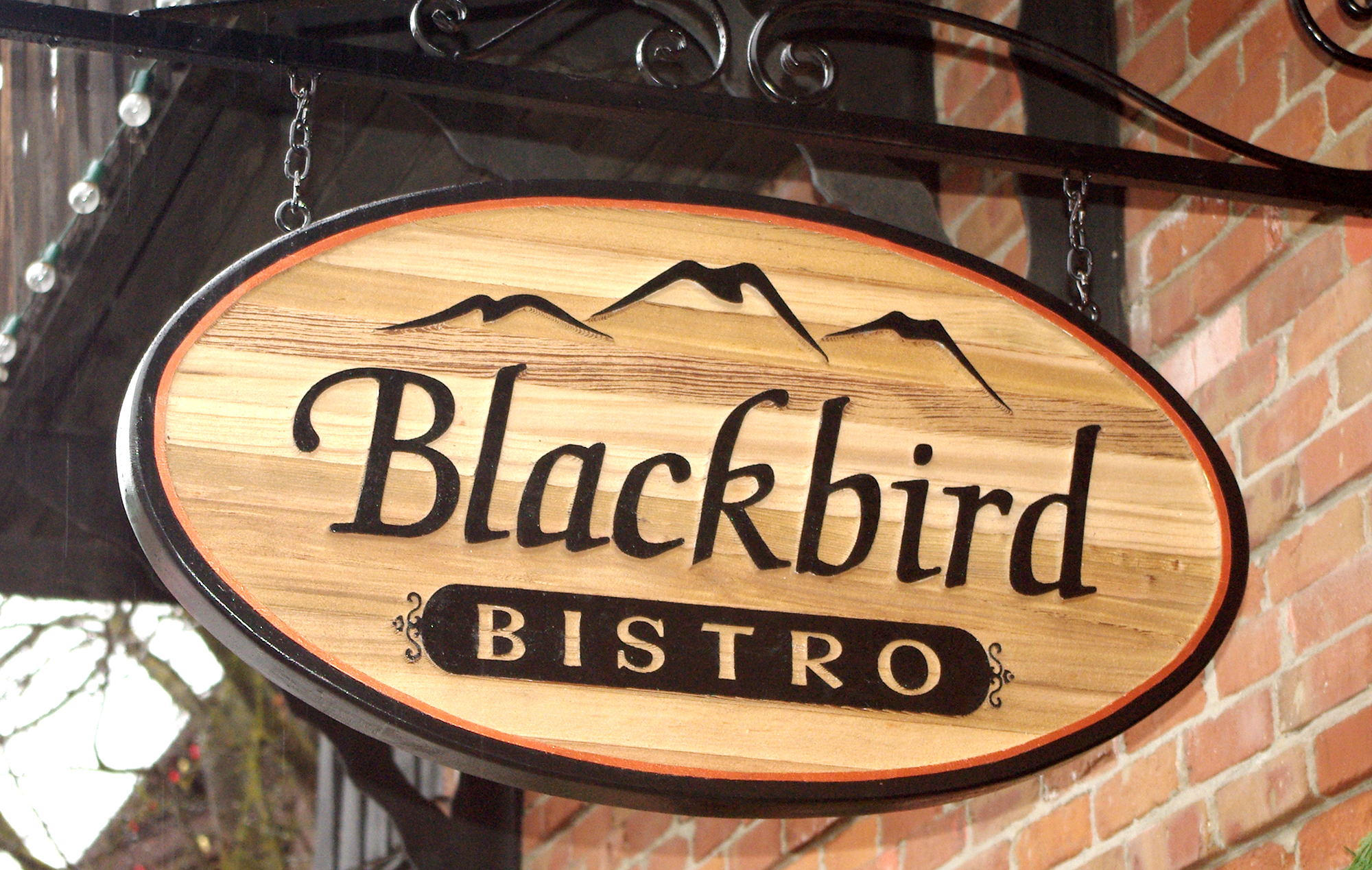 Finished Western Red Cedar hanging sign with sandblasted grain and carved lettering.